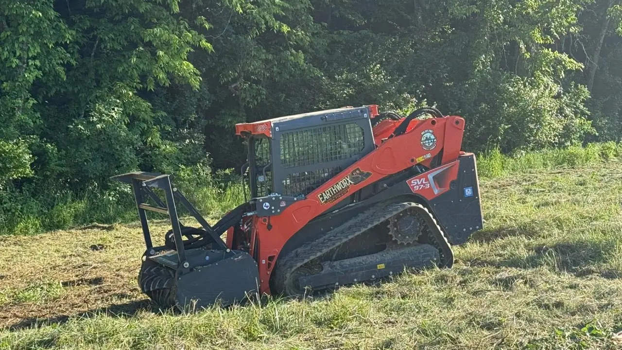 EarthWorx compact track loader on a freshly cleared field